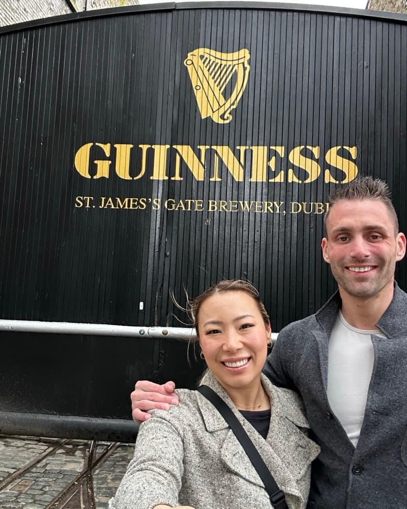 A selfie of Anna and Matt in front of the Guinness Storehouse gate at St. James's Gate, Dublin.